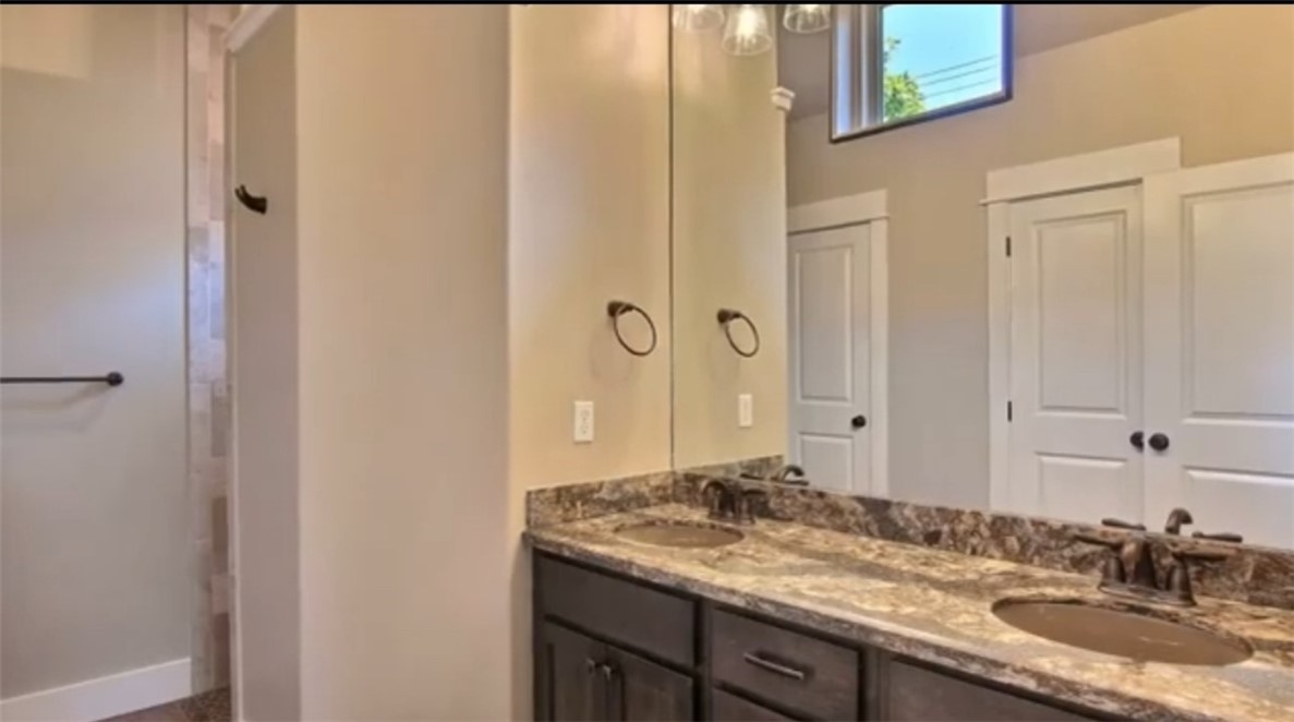 338 Southern Street Corpus Christi, TX 78404 - Photo 6 of 6 a bathroom with a granite countertop sink and a mirror