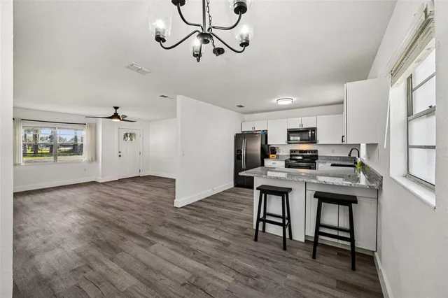 a view of a workspace with furniture and wooden floor