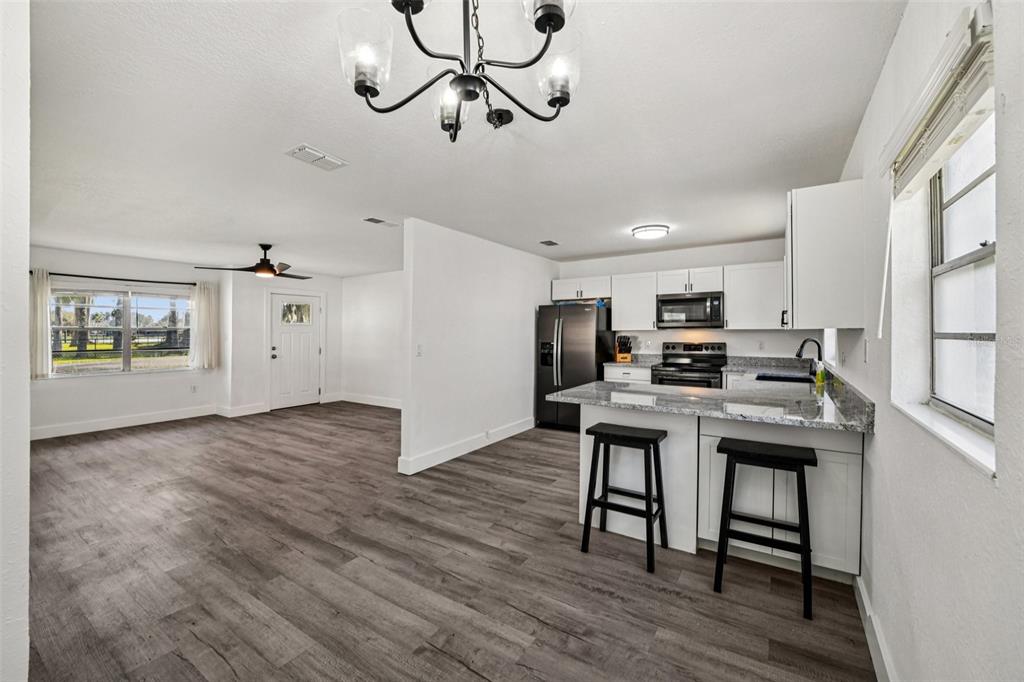 56305 Redbud Road Astor, FL 32102 - Photo 17 of 32 a view of a workspace with furniture and wooden floor