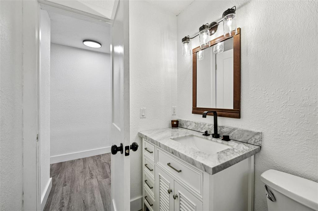 56305 Redbud Road Astor, FL 32102 - Photo 18 of 32 a bathroom with a sink and a mirror