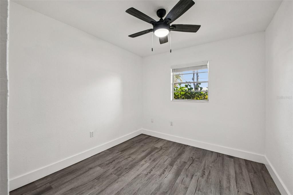56305 Redbud Road Astor, FL 32102 - Photo 20 of 32 an empty room with a window and a ceiling fan
