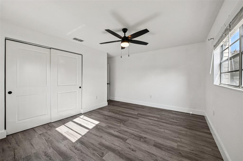 56305 Redbud Road Astor, FL 32102 - Photo 23 of 32 a view of empty room with wooden floor and fan