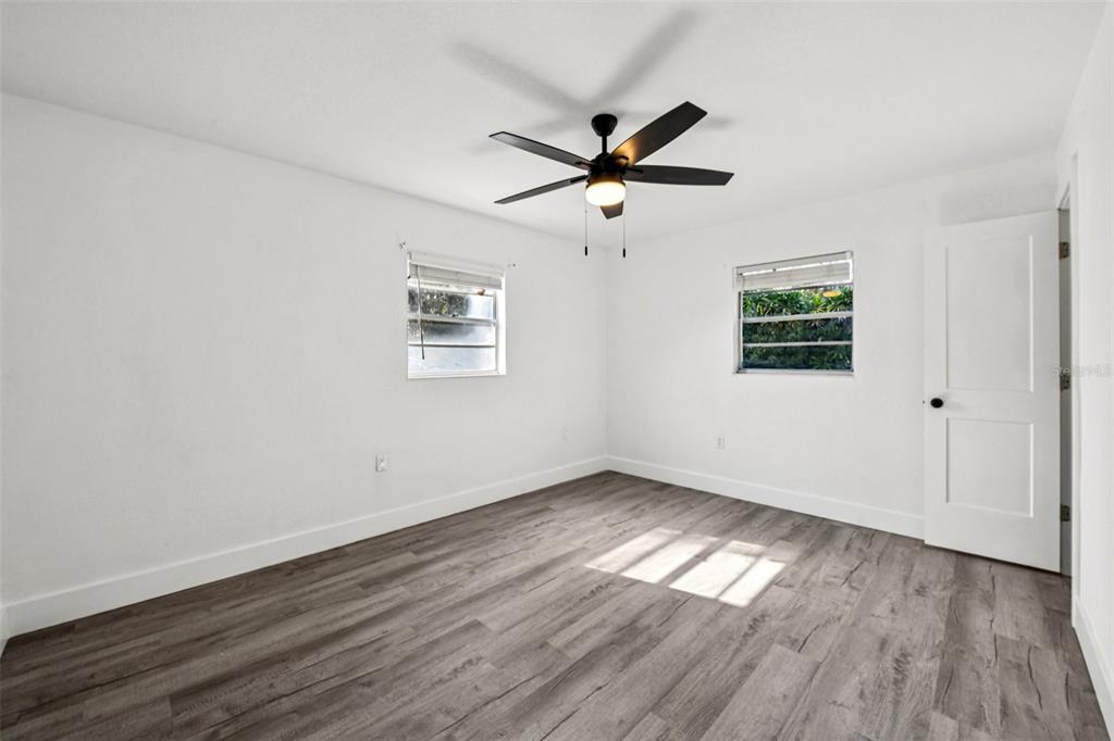 56305 Redbud Road Astor, FL 32102 - Photo 24 of 32 a view of empty room with wooden floor and fan