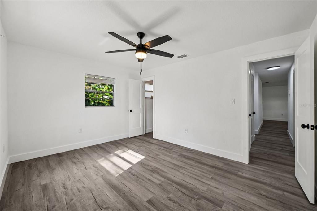 56305 Redbud Road Astor, FL 32102 - Photo 25 of 32 a view of empty room with wooden floor and fan