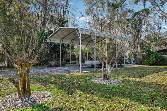a backyard of a house with barbeque oven