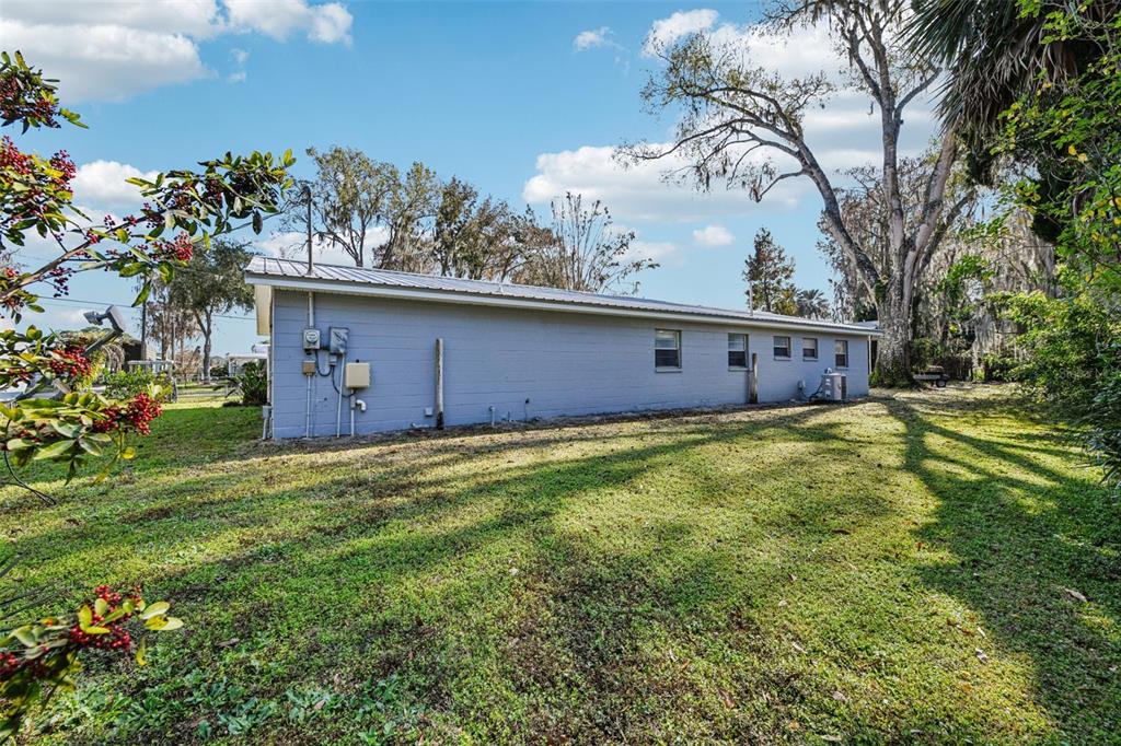 56305 Redbud Road Astor, FL 32102 - Photo 31 of 32 a view of a house with a backyard
