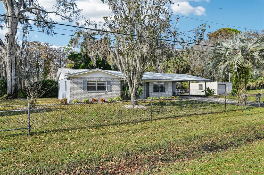 56305 Redbud Road Astor, FL 32102 - Photo 5 of 32 a front view of a house with a yard