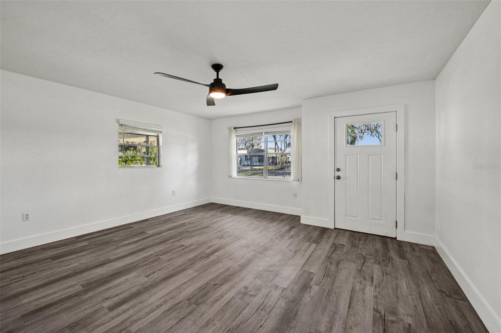 56305 Redbud Road Astor, FL 32102 - Photo 9 of 32 wooden floor in an empty room with a window