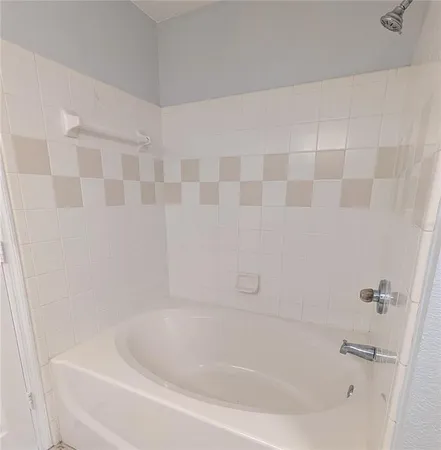 a bathroom with a granite countertop sink a toilet a mirror and shower