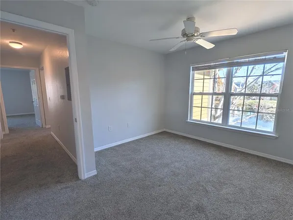 a view of an empty room and closet area