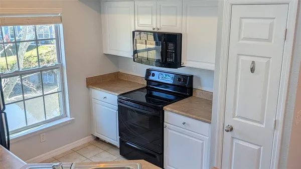 a view of a kitchen with an empty space and a window