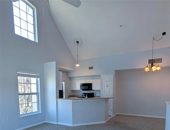 a living room with furniture and windows