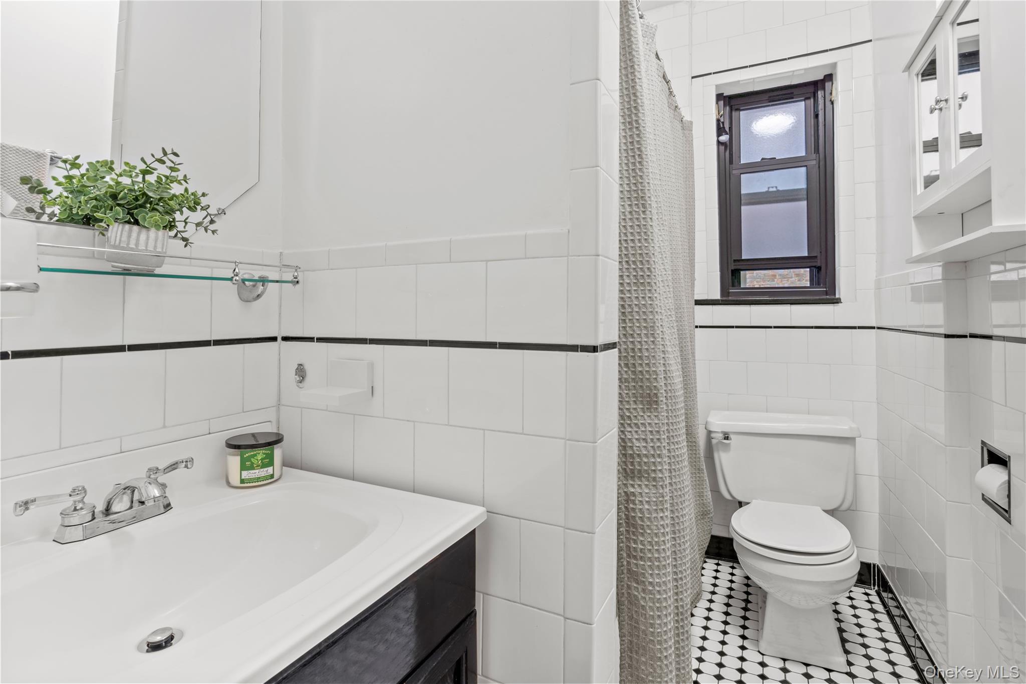 76-66 Austin Street, Unit 4B Queens, NY 11375 - Photo 6 of 12 Full bath featuring vanity, tile walls, a shower with shower curtain, and tile patterned flooring