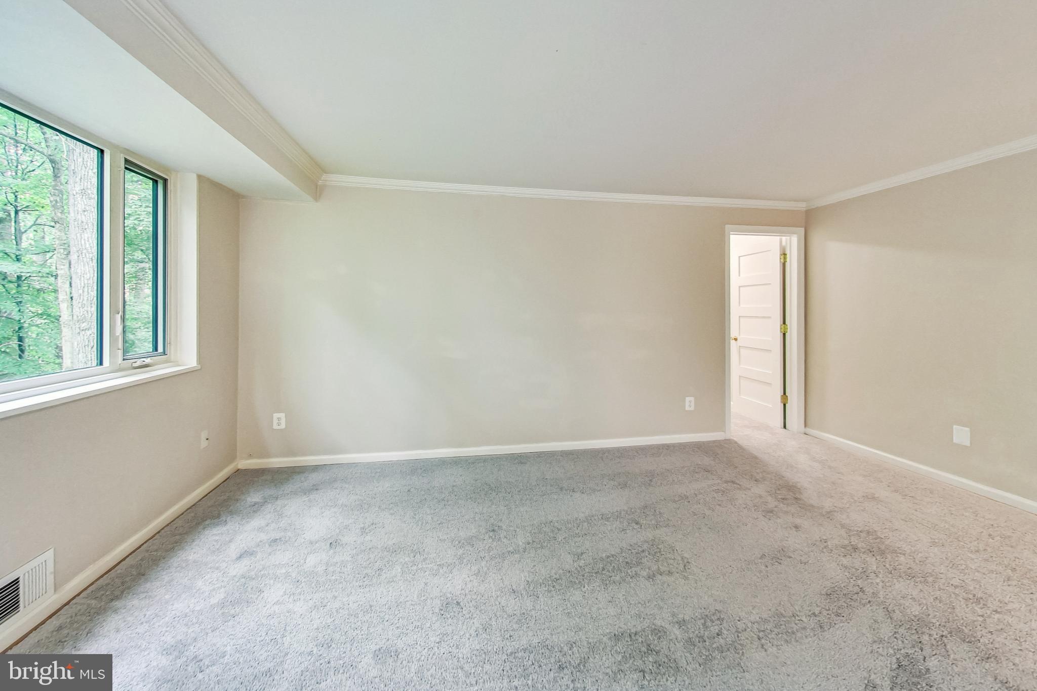 10501 Montrose Avenue, Unit 103 Bethesda, MD 20814 - Photo 13 of 27 an empty room with windows and closet