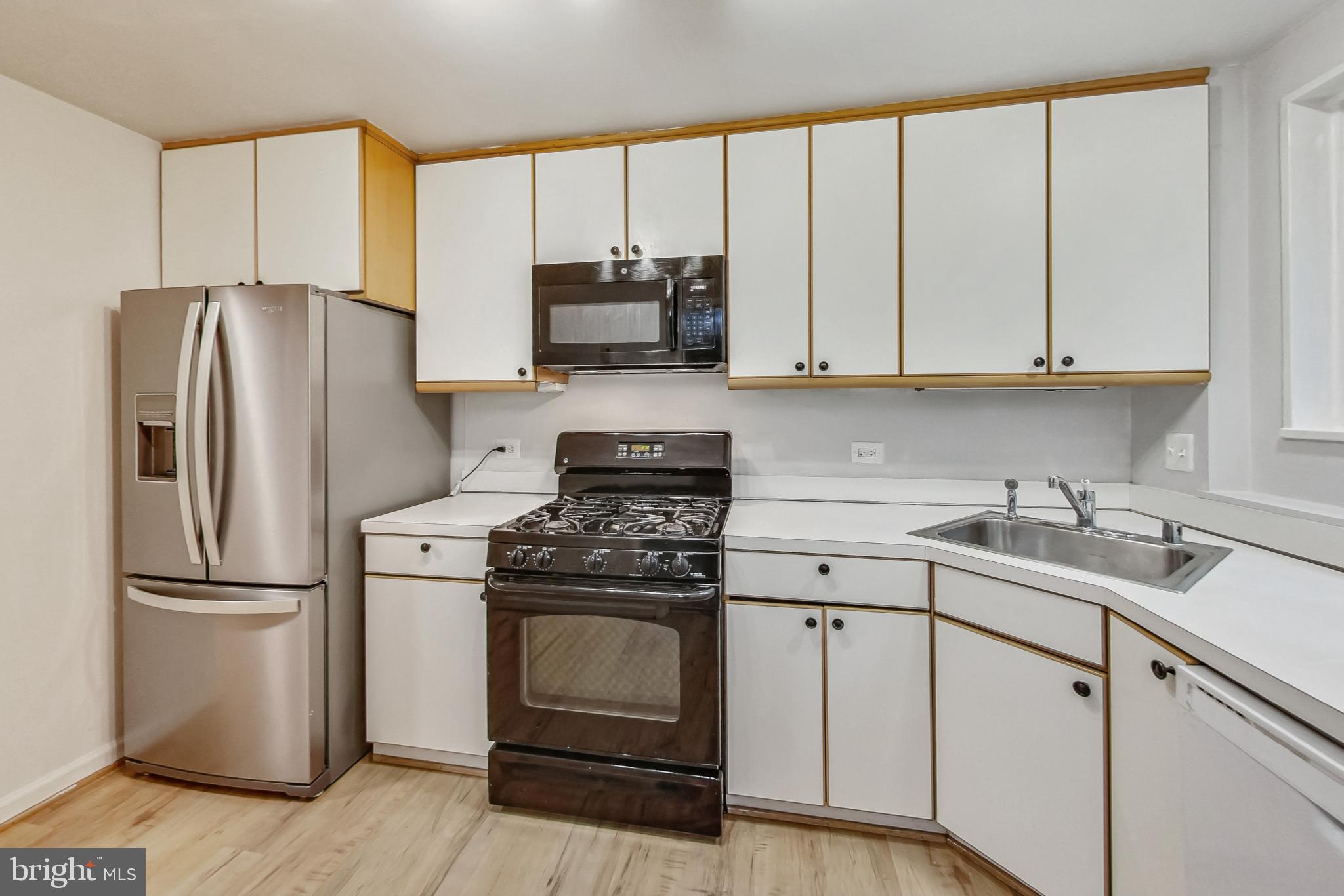 10501 Montrose Avenue, Unit 103 Bethesda, MD 20814 - Photo 19 of 27 a kitchen with a sink stove and refrigerator