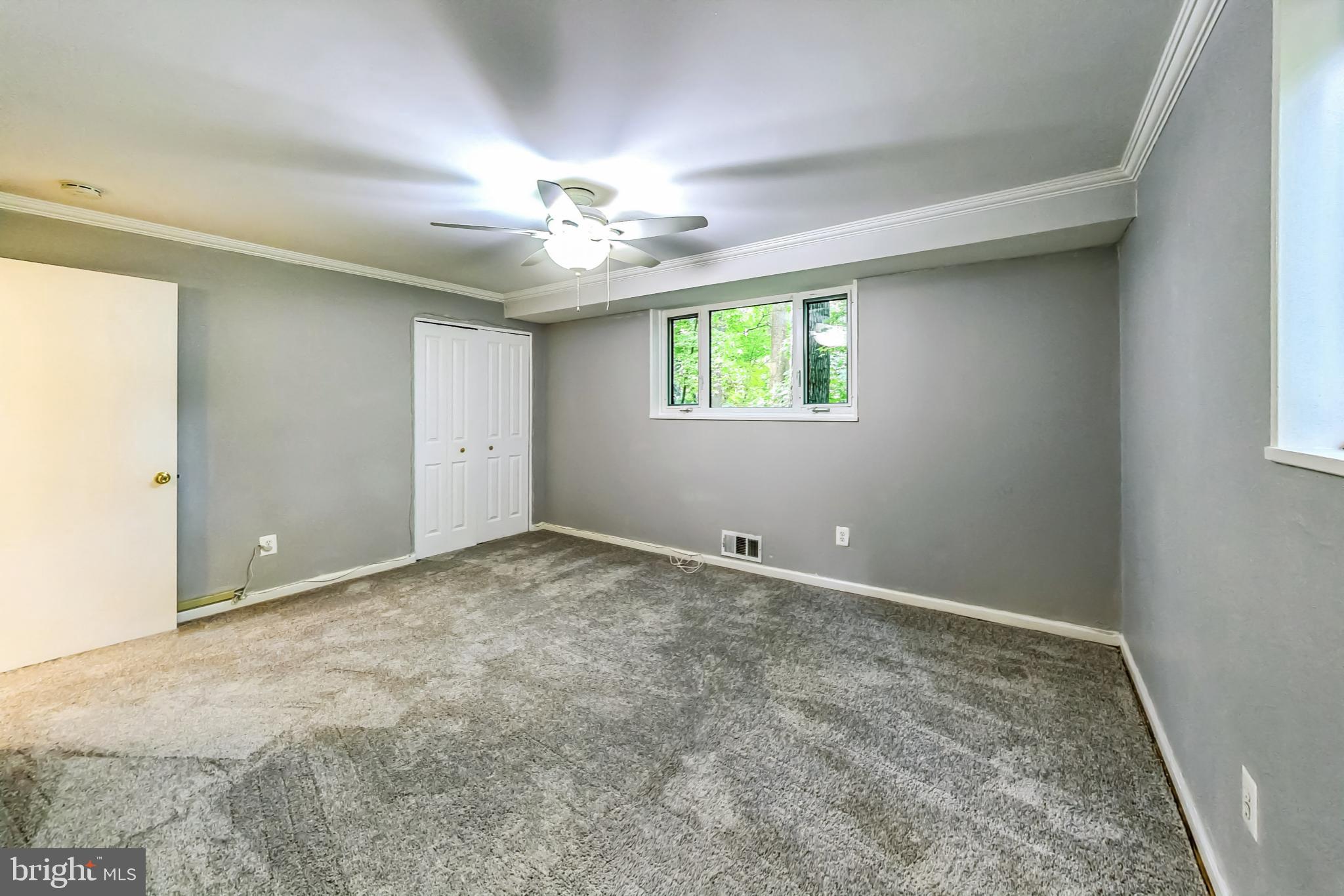 10501 Montrose Avenue, Unit 103 Bethesda, MD 20814 - Photo 22 of 27 an empty room with windows and ceiling fan