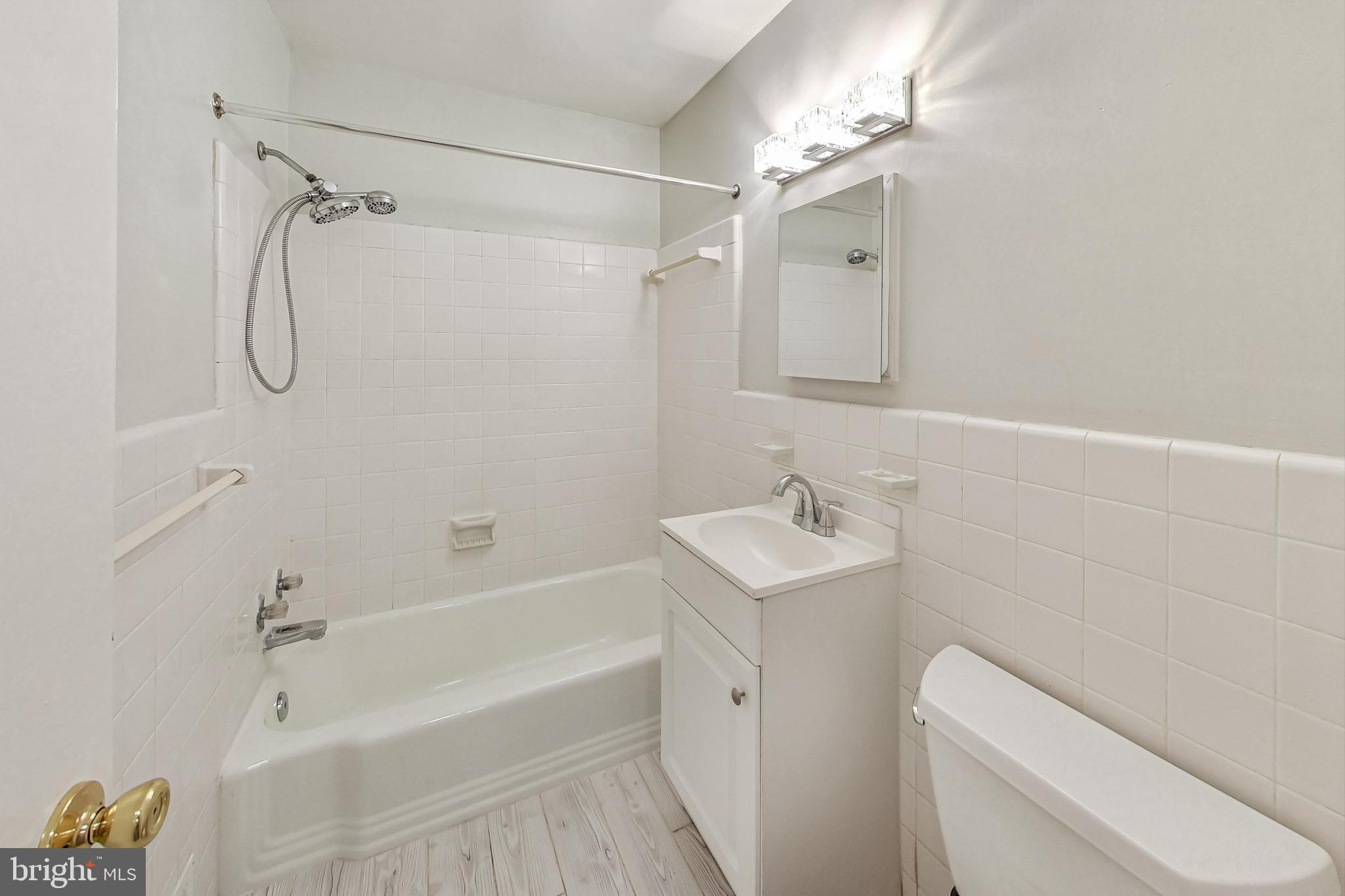 10501 Montrose Avenue, Unit 103 Bethesda, MD 20814 - Photo 27 of 27 a bathroom with a sink a toilet and shower