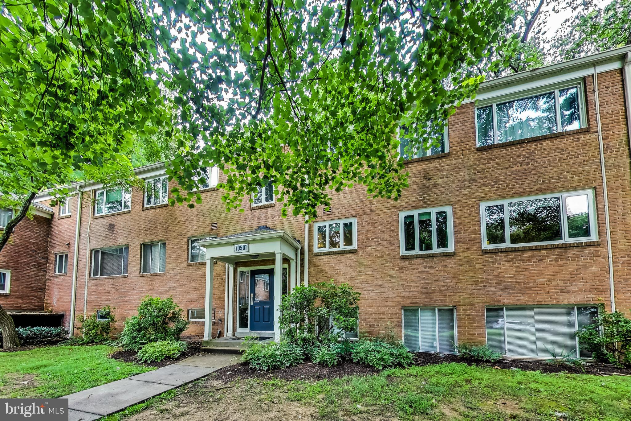 10501 Montrose Avenue, Unit 103 Bethesda, MD 20814 - Photo 3 of 27 a front view of a house with garden
