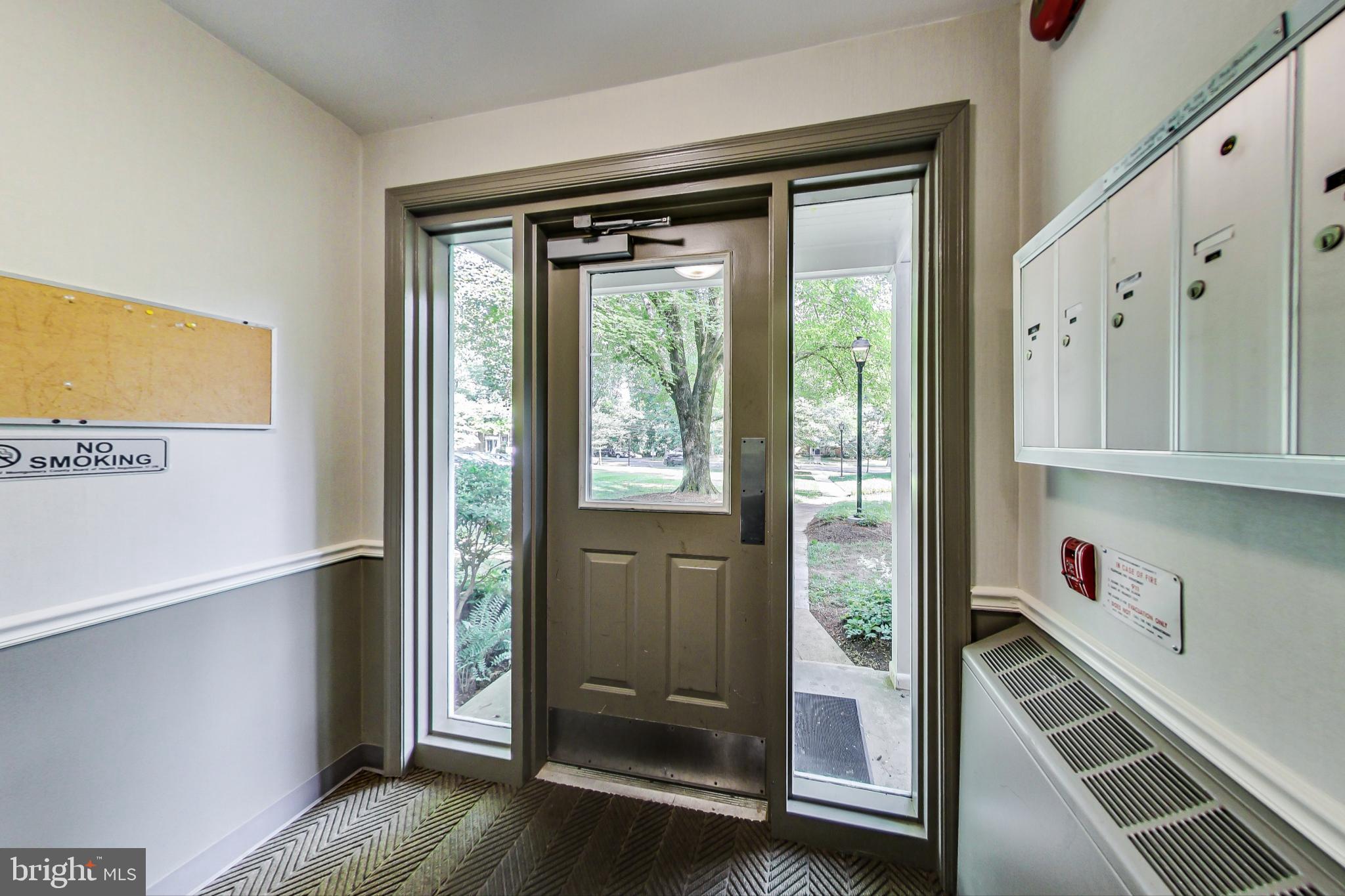 10501 Montrose Avenue, Unit 103 Bethesda, MD 20814 - Photo 7 of 27 a view of a hallway with wooden floor and windows