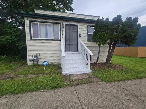 a front view of a house with garden