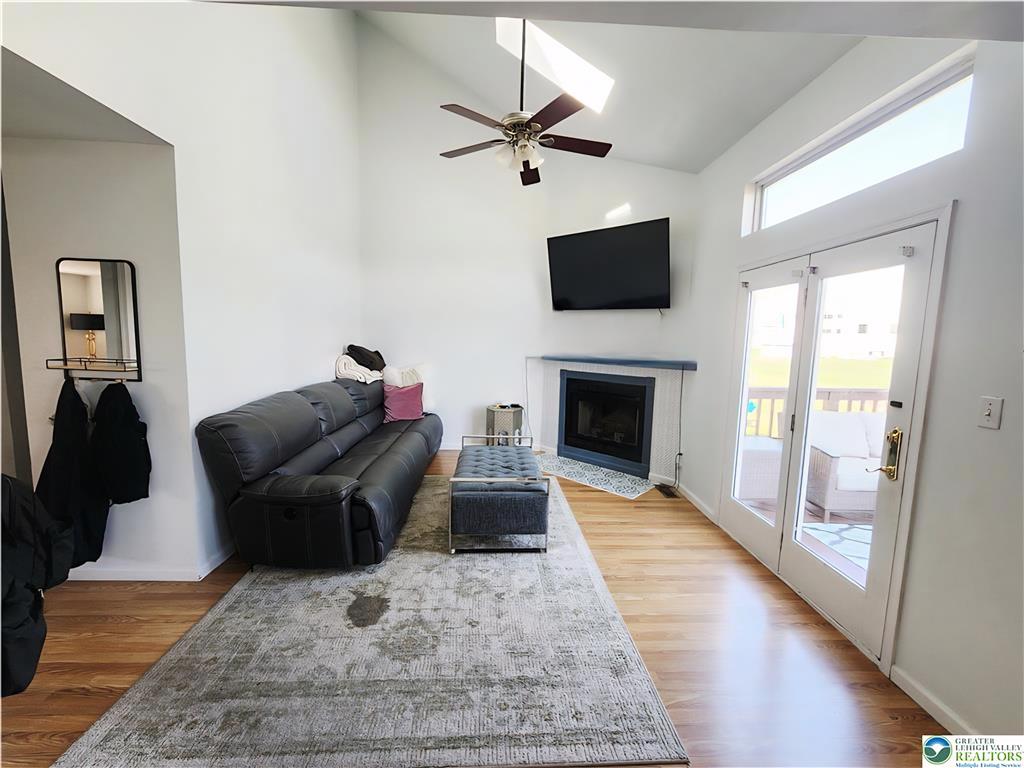 237 Ridings Circle Macungie, PA 18062 - Photo 26 of 70 Gleaming hardwood floors and a lofty vaulted ceiling anchor this inviting fireplace-warmed gathering space.