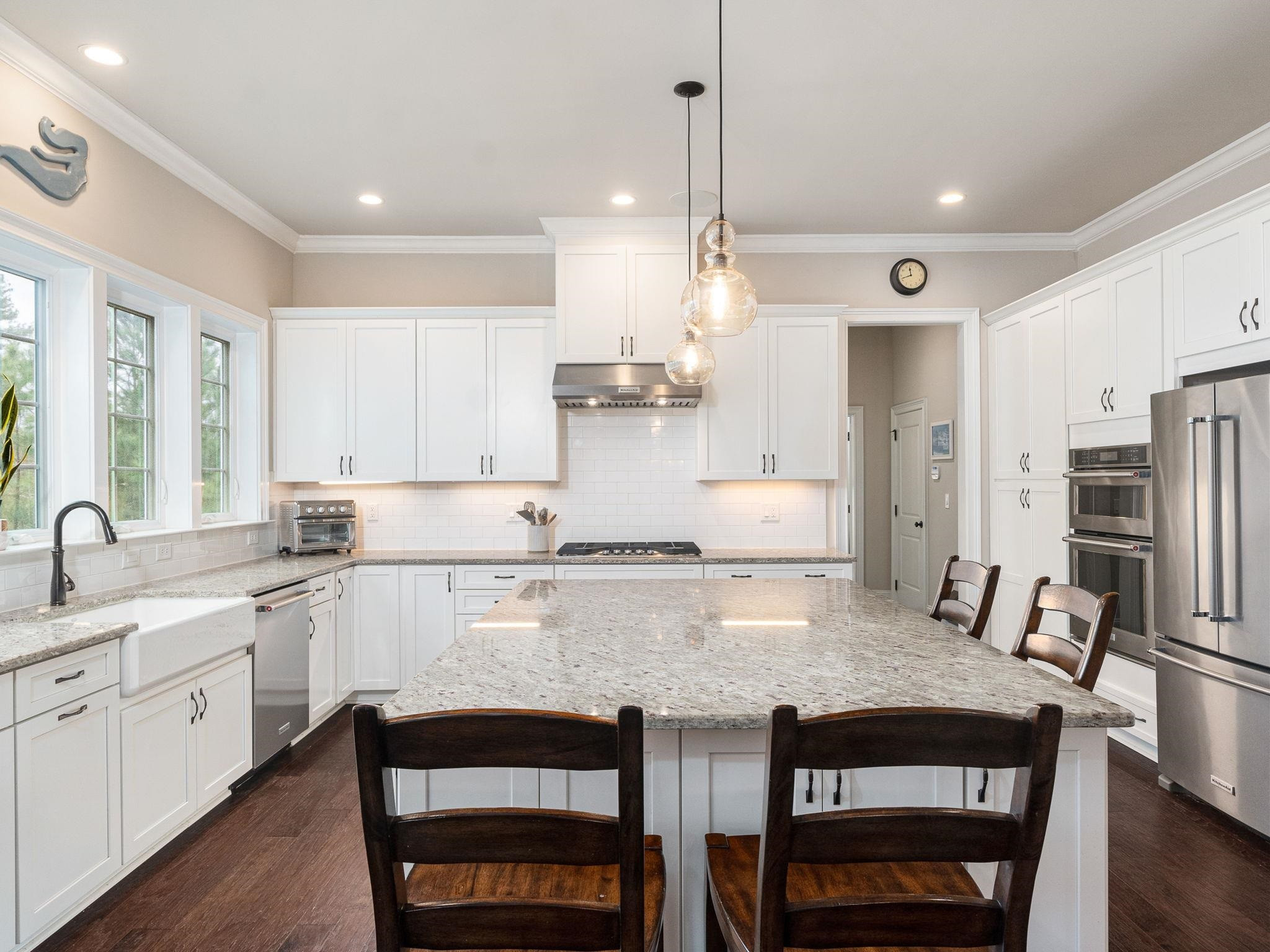 7532 Hasentree Way Wake Forest, NC 27587 - Photo 12 of 40 a kitchen with stainless steel appliances granite countertop a stove a sink dishwasher and a refrigerator with wooden floor