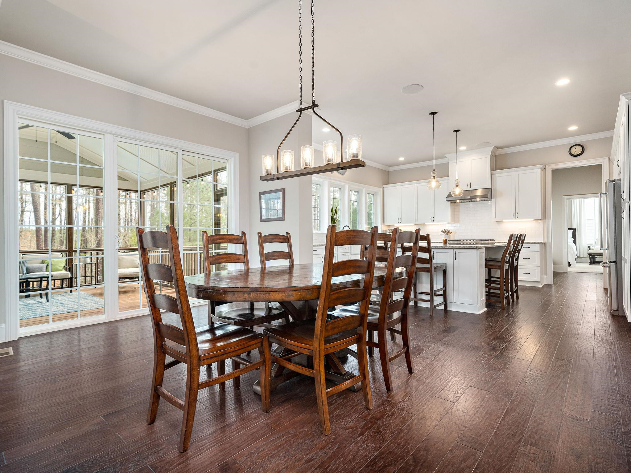7532 Hasentree Way Wake Forest, NC 27587 - Photo 14 of 40 a view of a dining room and livingroom with furniture wooden floor a chandelier