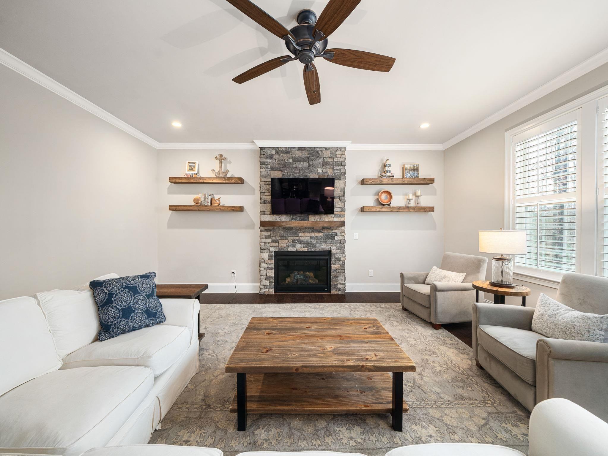 7532 Hasentree Way Wake Forest, NC 27587 - Photo 17 of 40 a living room with furniture a fireplace and a window