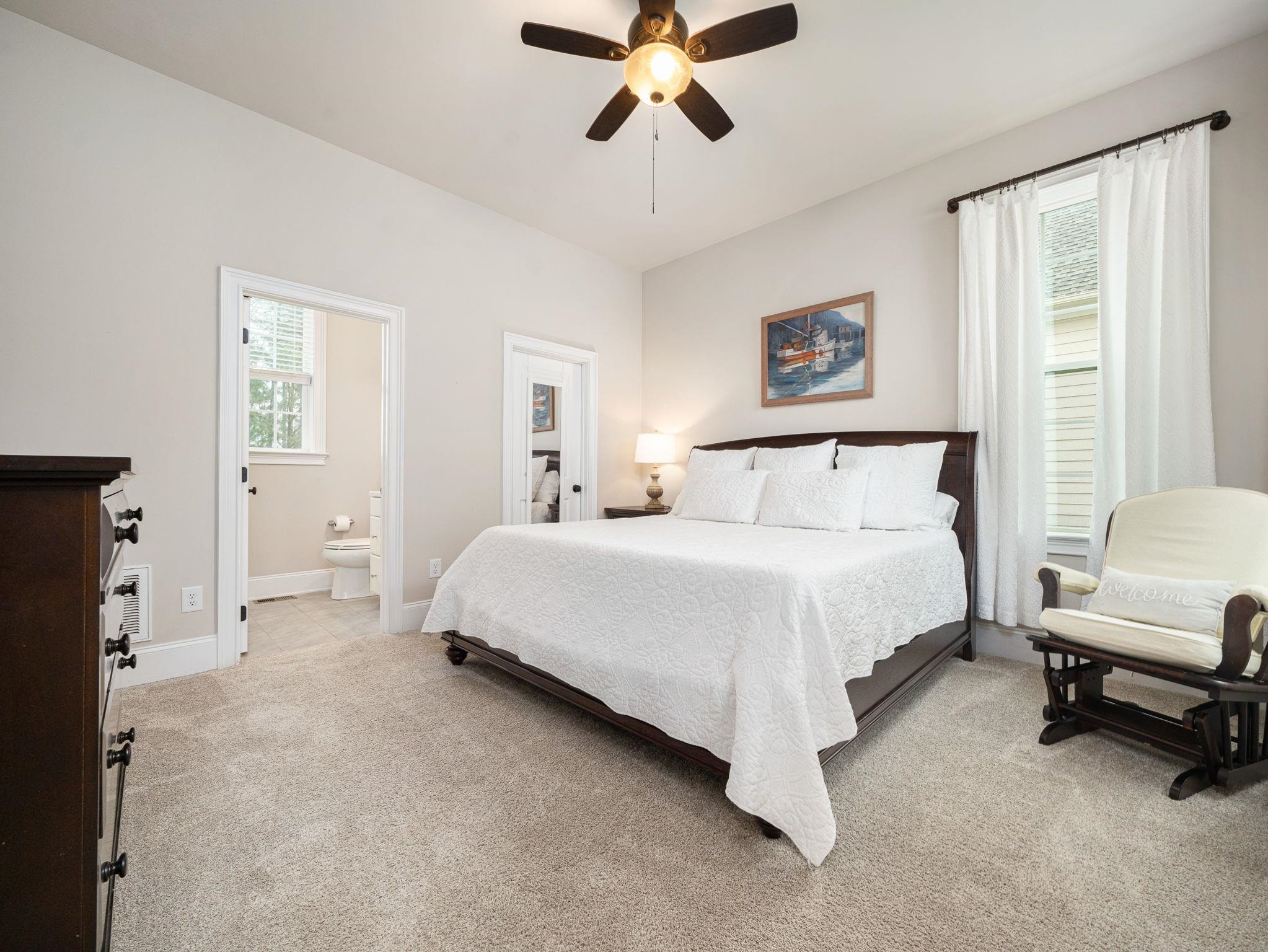 7532 Hasentree Way Wake Forest, NC 27587 - Photo 19 of 40 a spacious bedroom with a bed and a chandelier