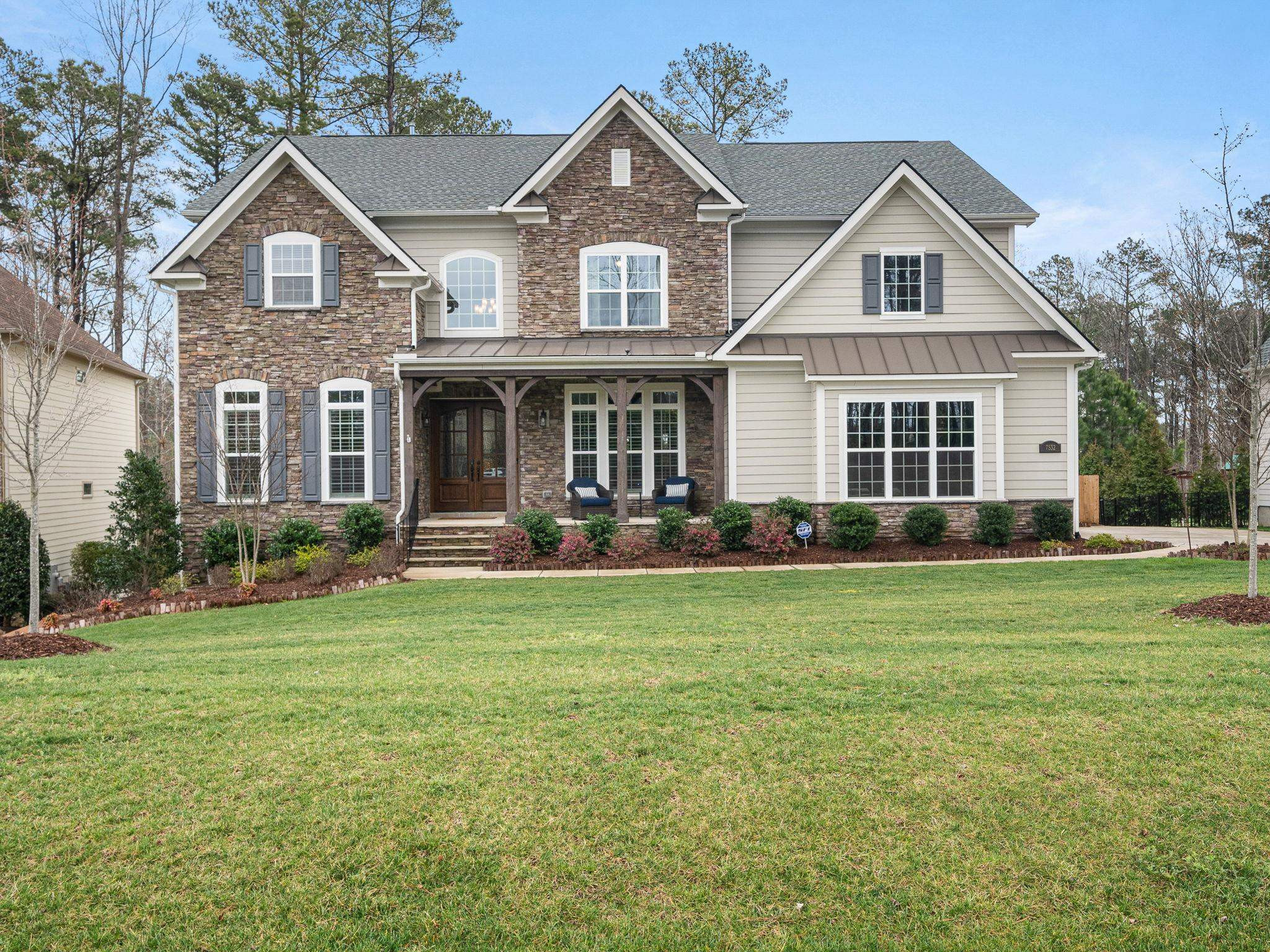 7532 Hasentree Way Wake Forest, NC 27587 - Photo 2 of 40 a front view of a house with a yard and trees