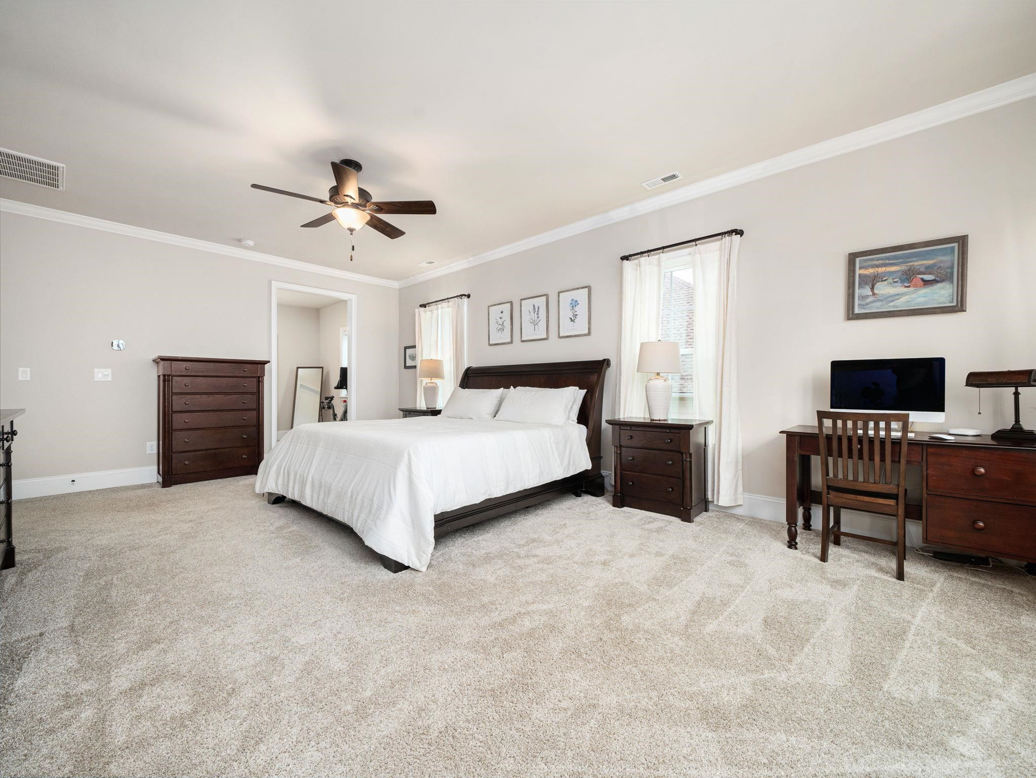7532 Hasentree Way Wake Forest, NC 27587 - Photo 24 of 40 a spacious bedroom with a bed and a chandelier