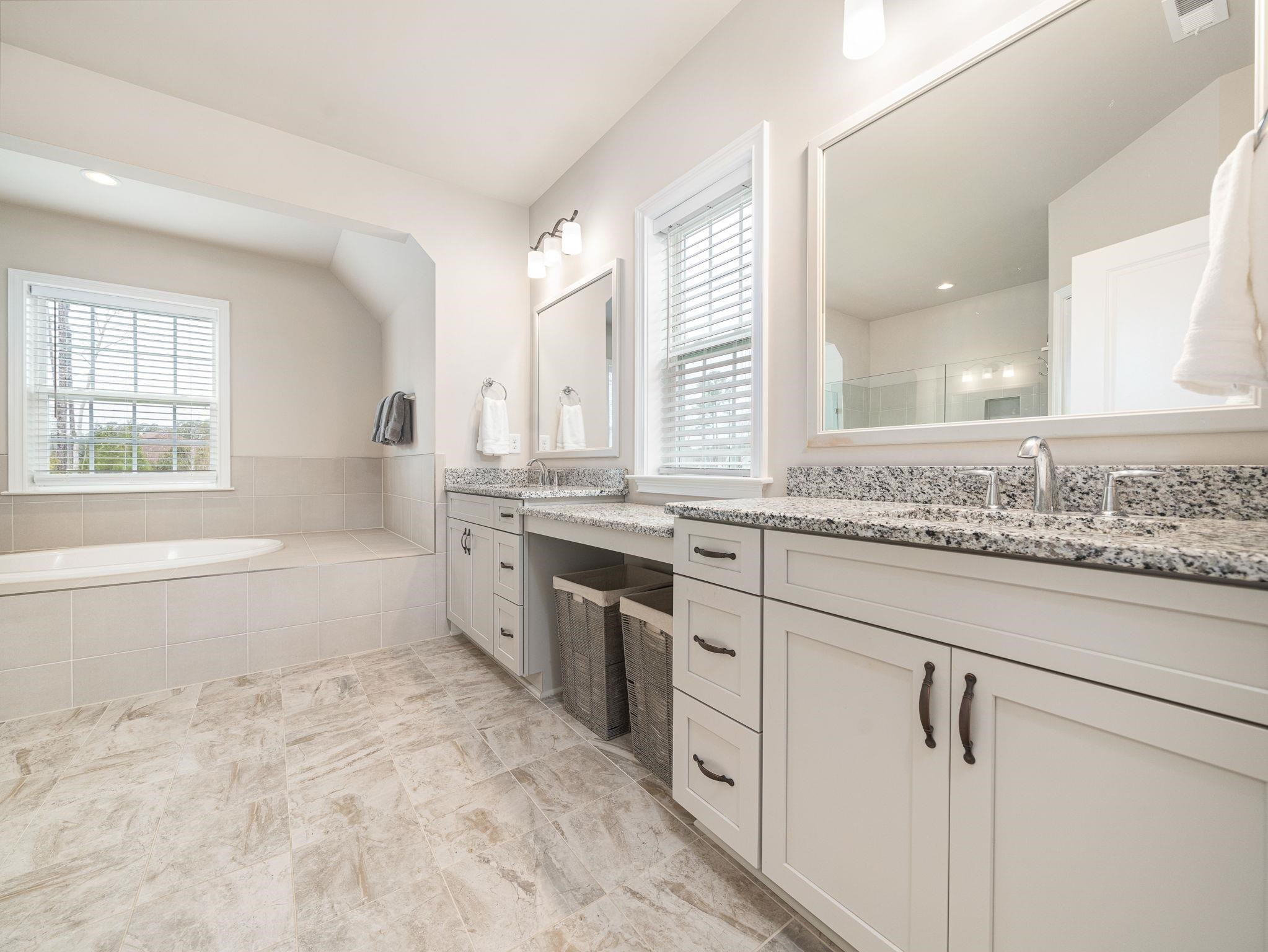 7532 Hasentree Way Wake Forest, NC 27587 - Photo 25 of 40 a bathroom with a granite countertop sink mirror vanity and bathtub