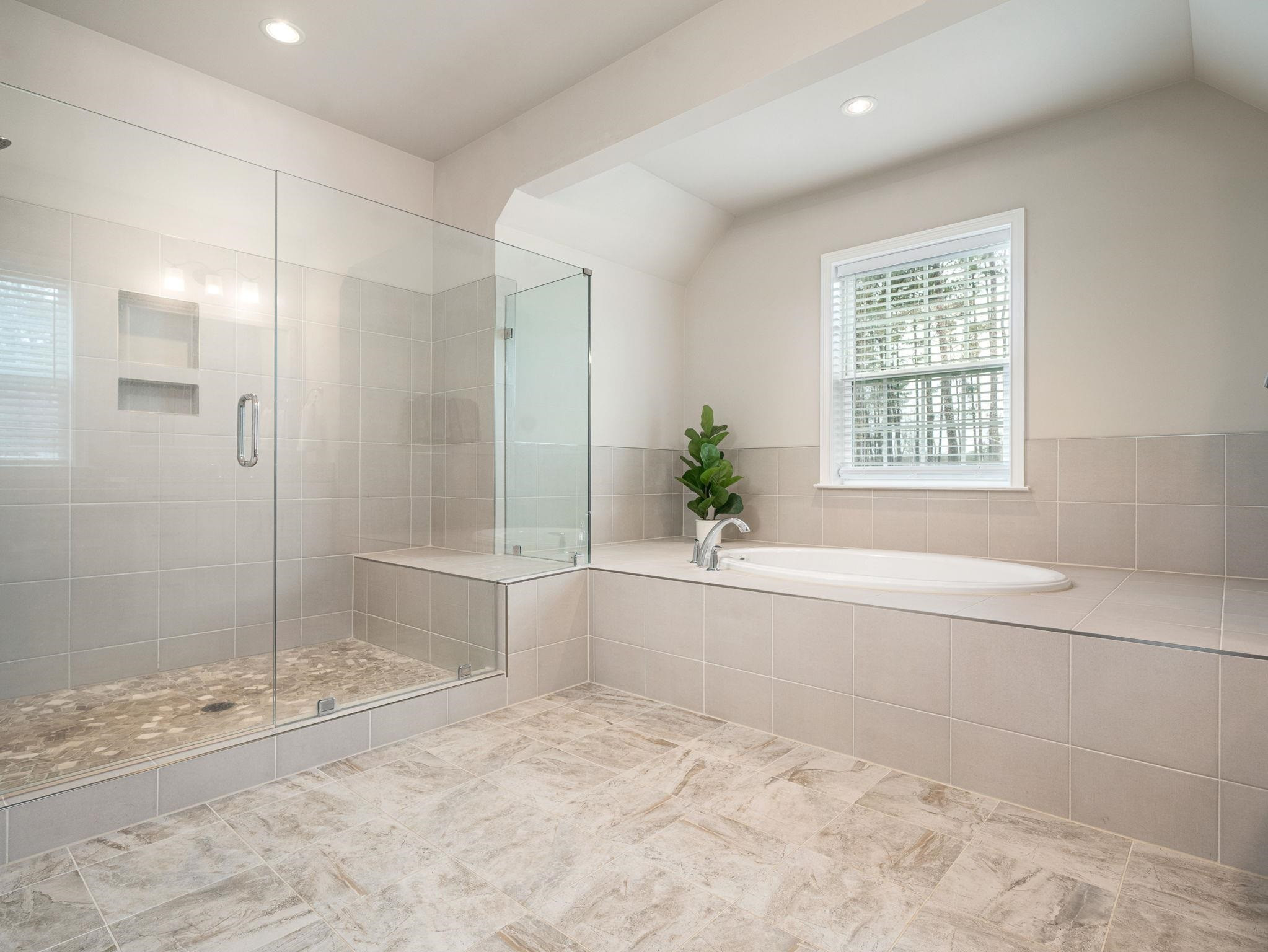 7532 Hasentree Way Wake Forest, NC 27587 - Photo 26 of 40 a bathroom with a granite countertop bathtub and shower