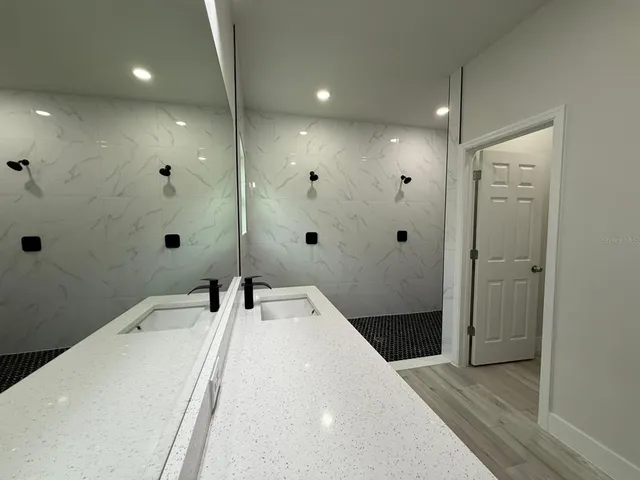a bathroom with a tub sink and shower