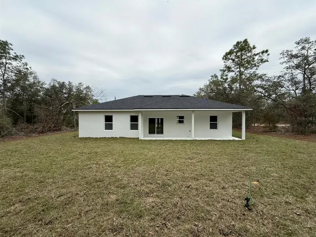 a house view with a backyard space
