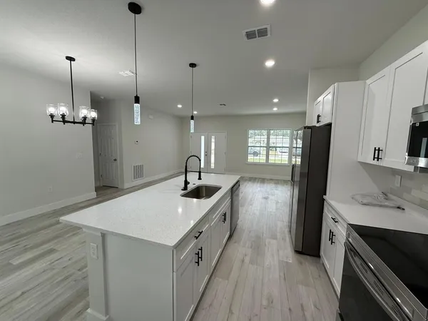 a kitchen with a sink stove and refrigerator