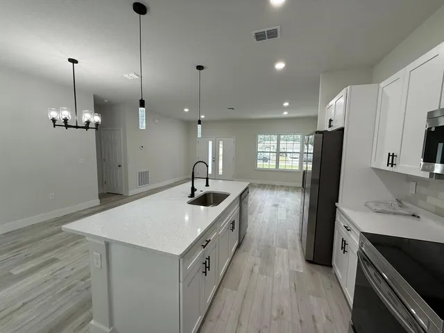 a kitchen with a sink stove and refrigerator