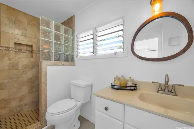 a bathroom with a toilet a sink and a mirror