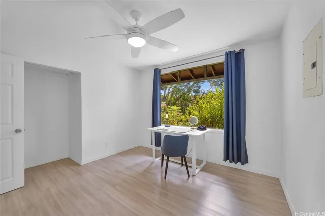 a view of a livingroom with furniture window and wooden floor