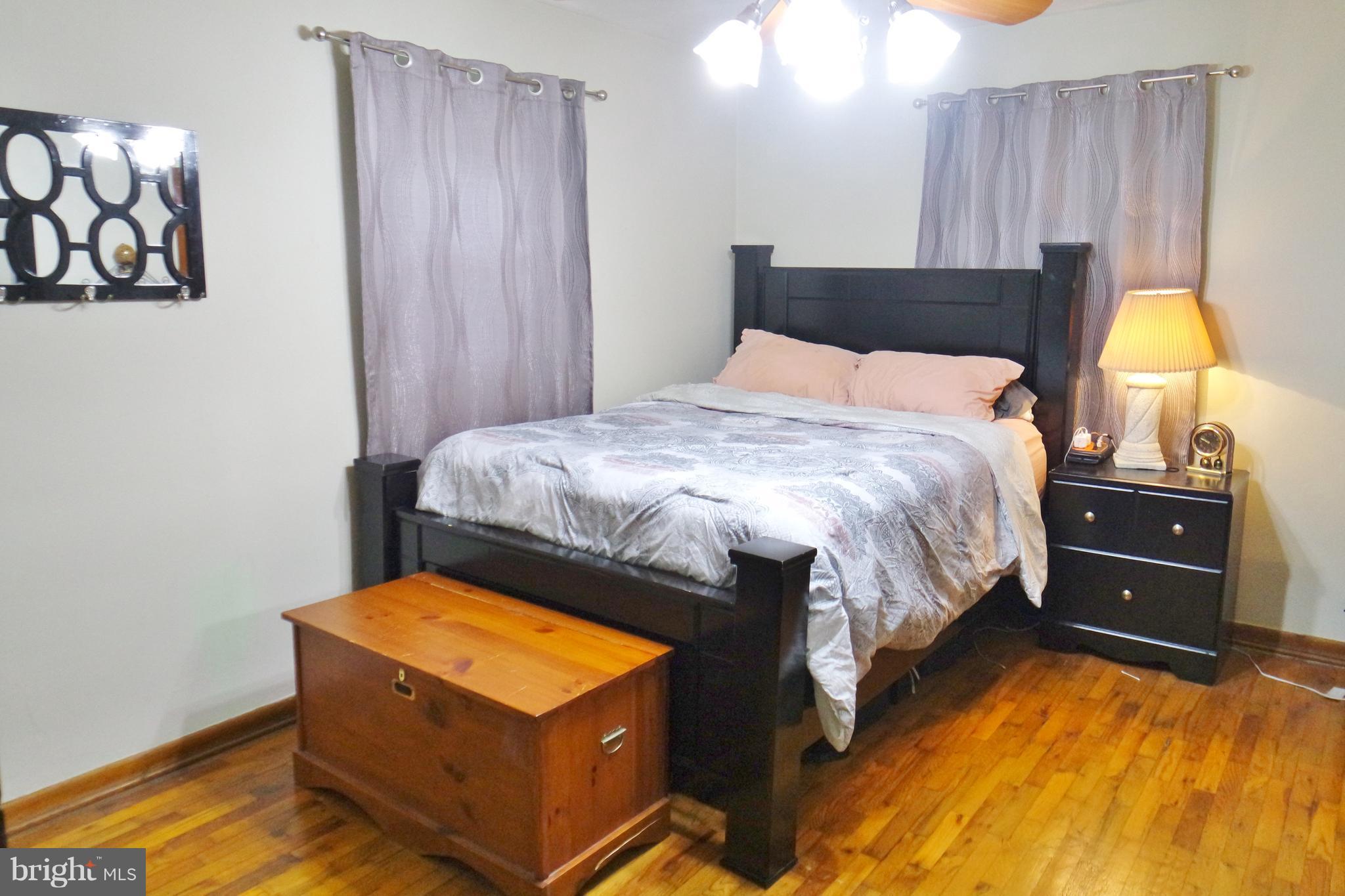 293 Valley Mill Road Winchester, VA 22602 - Photo 14 of 29 a bedroom with a bed and a lamp