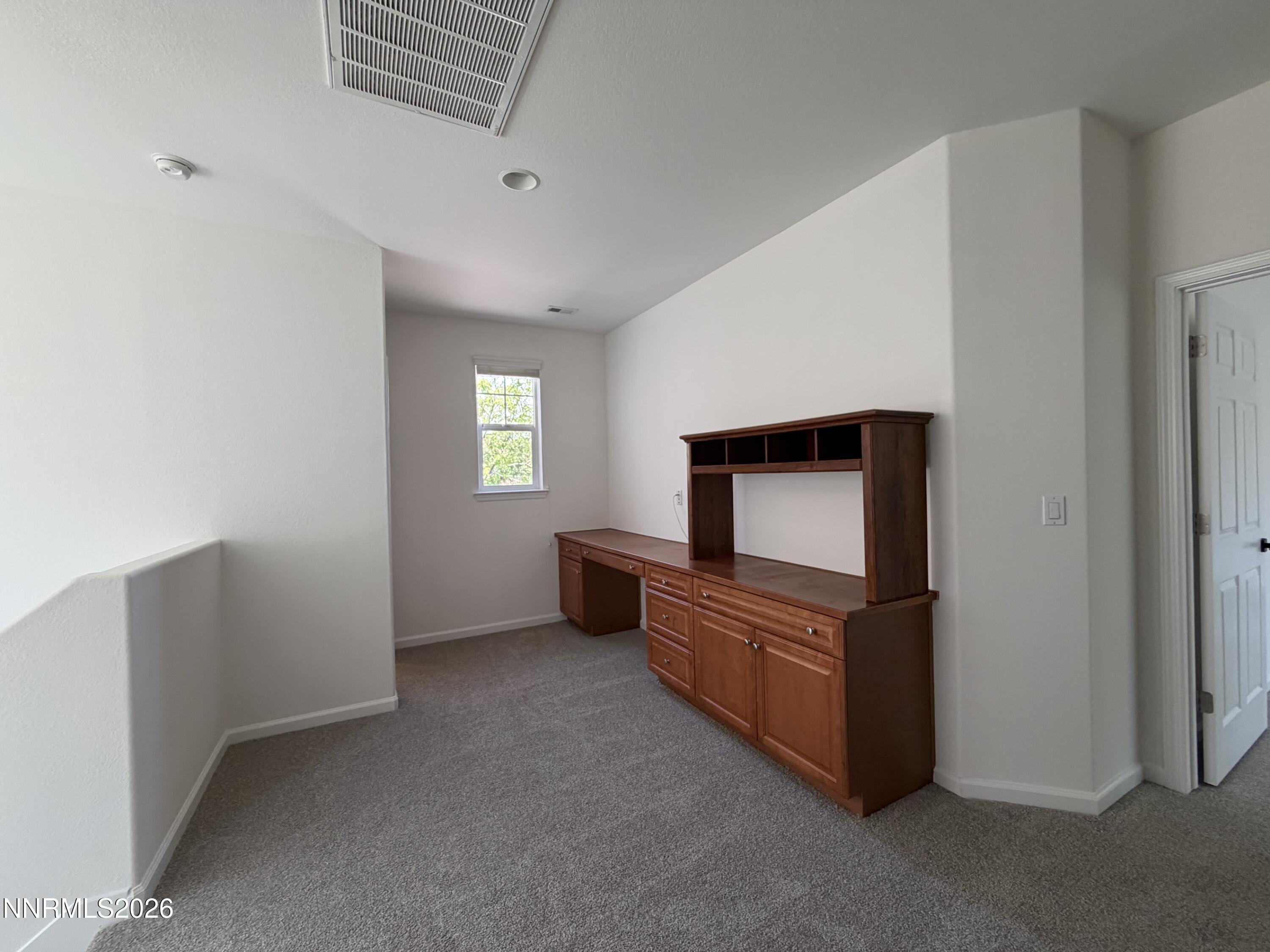 10890 Oakhaven Drive Reno, NV 89521 - Photo 19 of 28 a view of an empty room with wooden floor and cabinet
