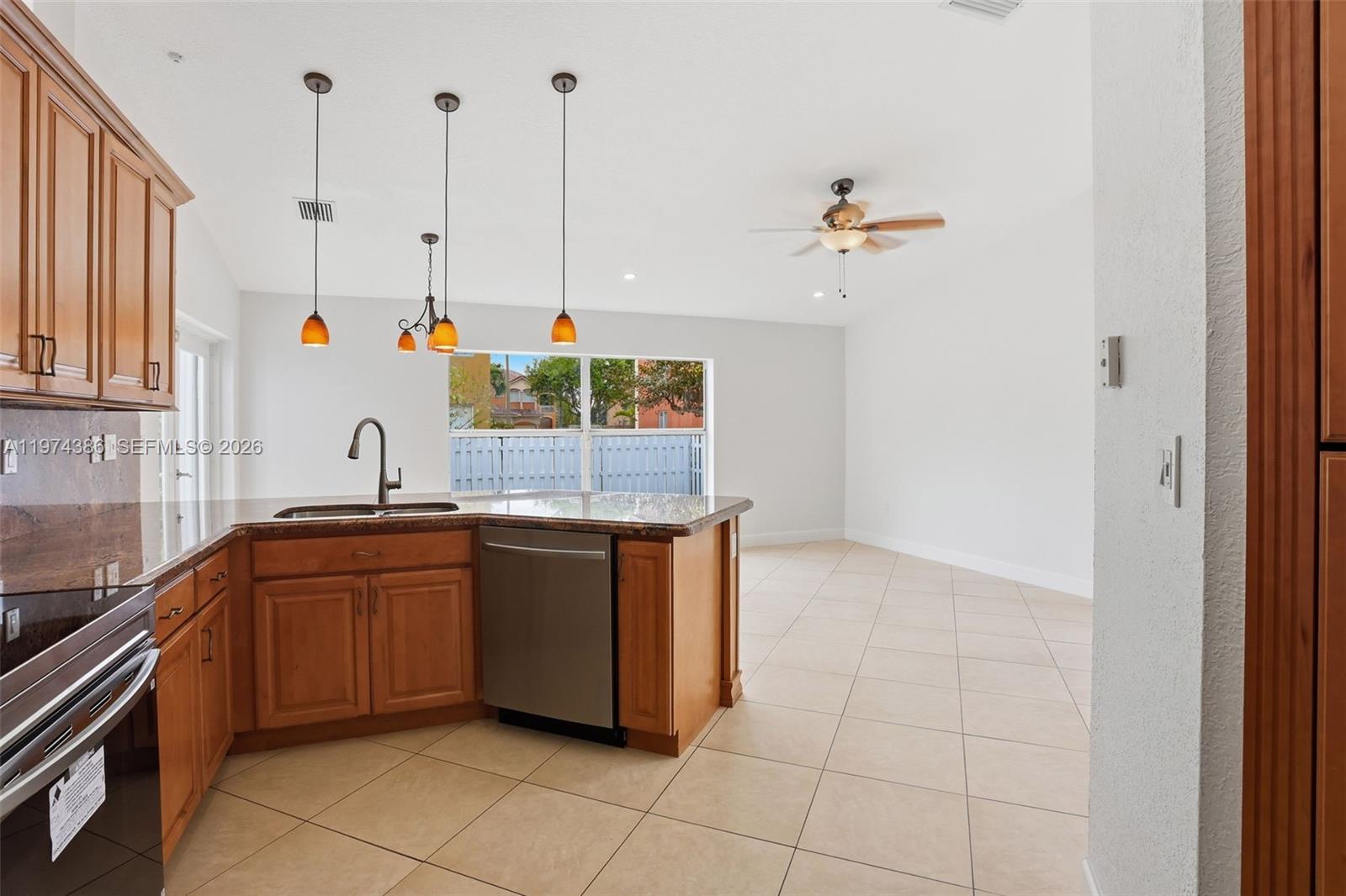 12930 Southwest 20th Street Miramar, FL 33027 - Photo 12 of 48 a kitchen with a sink and cabinets
