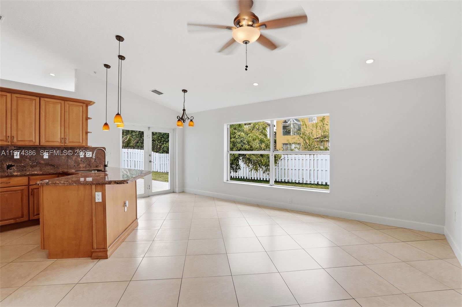 12930 Southwest 20th Street Miramar, FL 33027 - Photo 18 of 48 a kitchen with stainless steel appliances granite countertop a stove a sink and a refrigerator