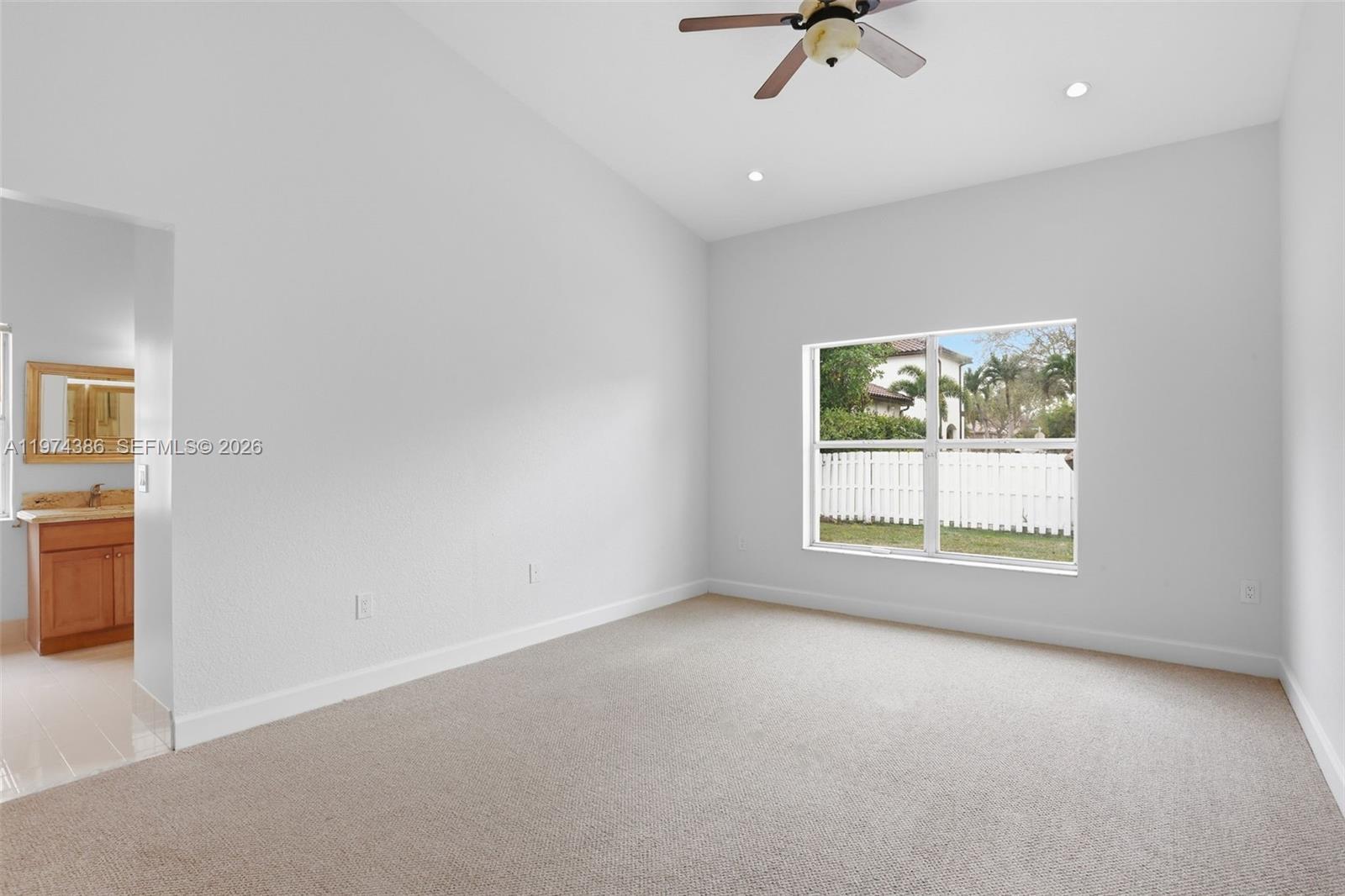 12930 Southwest 20th Street Miramar, FL 33027 - Photo 20 of 48 an empty room with a window and a ceiling fan