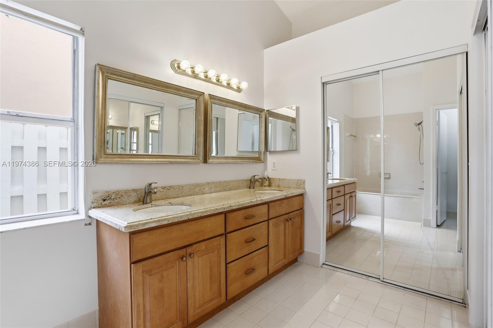 12930 Southwest 20th Street Miramar, FL 33027 - Photo 21 of 48 a spacious bathroom with a granite countertop sink mirror and a