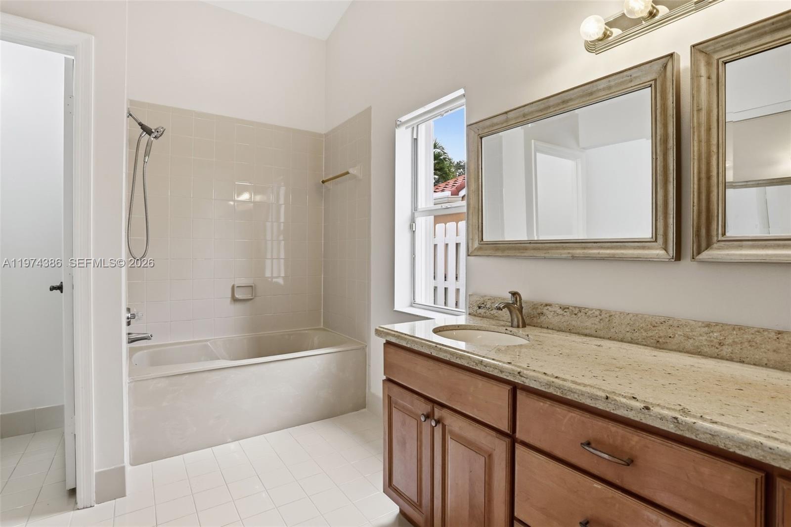 12930 Southwest 20th Street Miramar, FL 33027 - Photo 22 of 48 a bathroom with a granite countertop sink mirror toilet and bathtub
