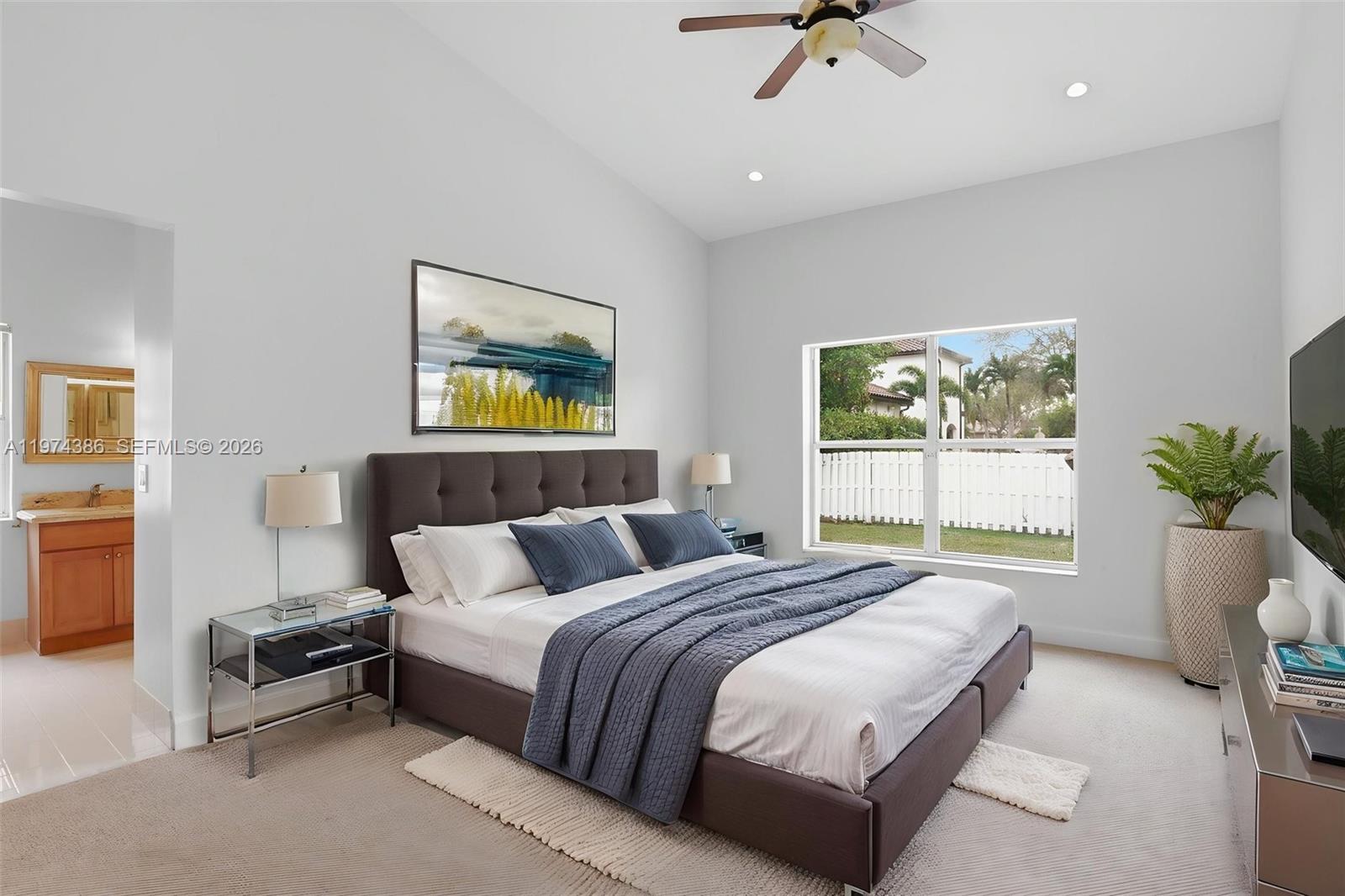 12930 Southwest 20th Street Miramar, FL 33027 - Photo 23 of 48 a bedroom with a bed lamps and window