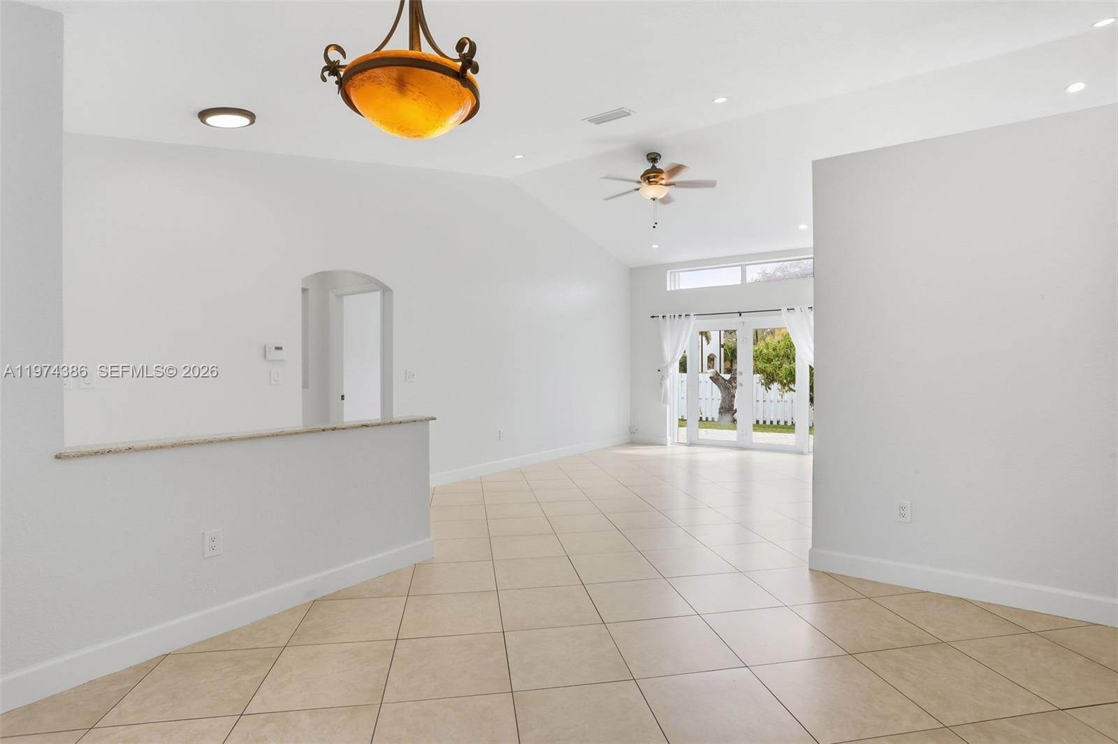 12930 Southwest 20th Street Miramar, FL 33027 - Photo 9 of 48 a view of an empty room with window and wooden floor