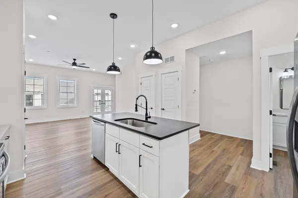 a kitchen with sink stove and refrigerator
