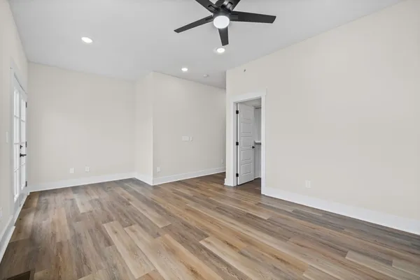 a view of an empty room and wooden floor